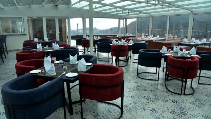 A different seating arrangement in The House of Glass, a rooftop restaurant in Shimla - The Orchid Hotel Shimla