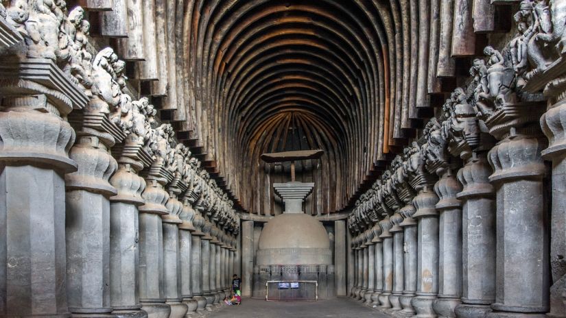 A very long room with many statues on the walls.