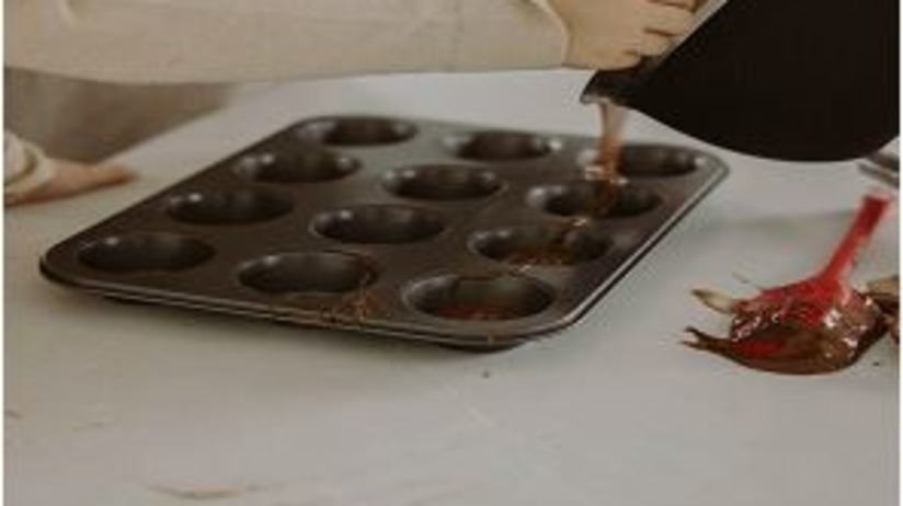 A person pouring batter into a silicon mould