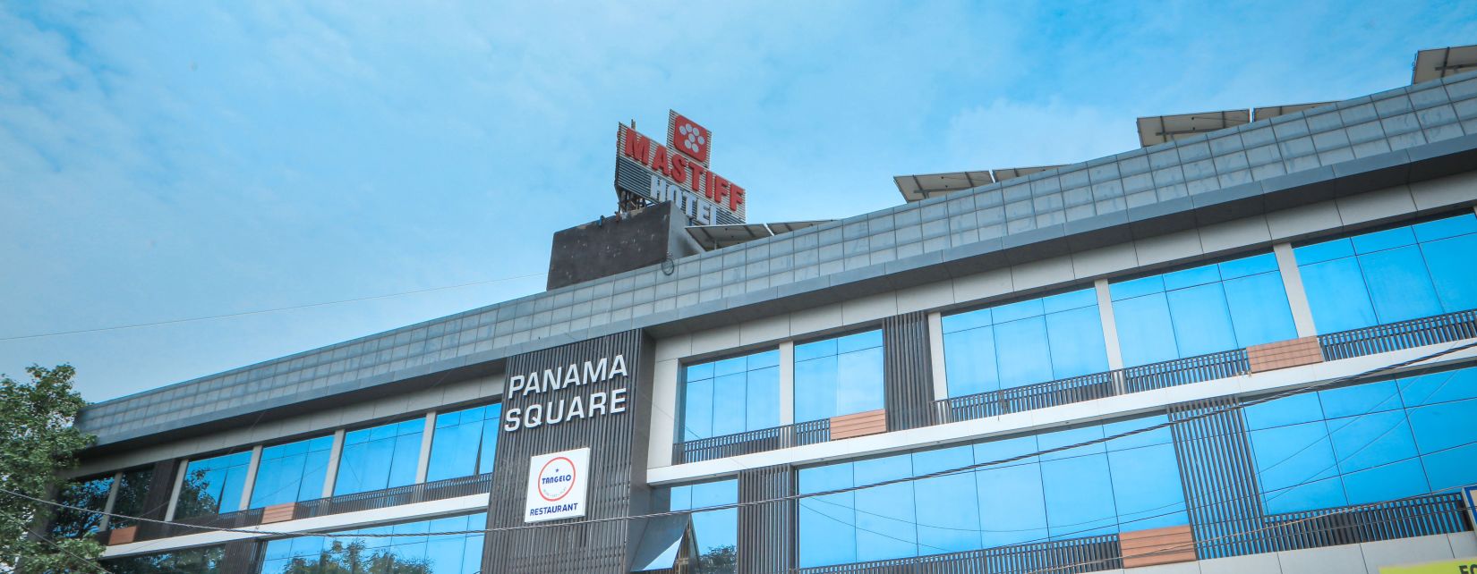 facade of a hotel building with blue sky as the  backdrop - Mastiff Hotel, Ankleshwar