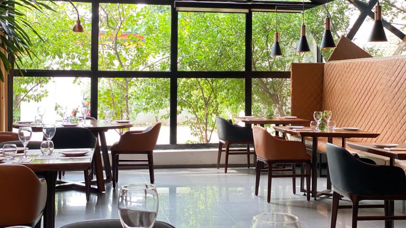 View of dining area with several tables and chair, all designed in contemporary style - Mastiff Grand- The Sia Palace Suites and Banquets, Khopoli