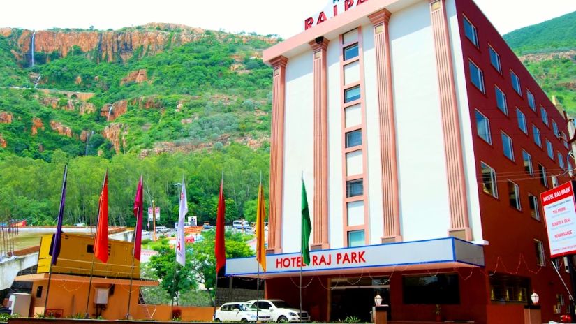 Facade of Raj Park Hotel, Tirupati with a mountain in the background