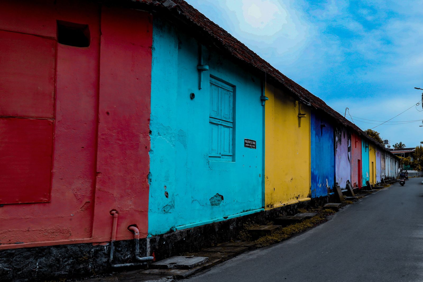 colourfully painted row houses on a street in Kochi