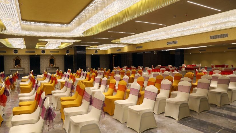 Theatre style seating arrangements inside the banquet hall with modern lights on the ceiling - VITS Bharat Nanded