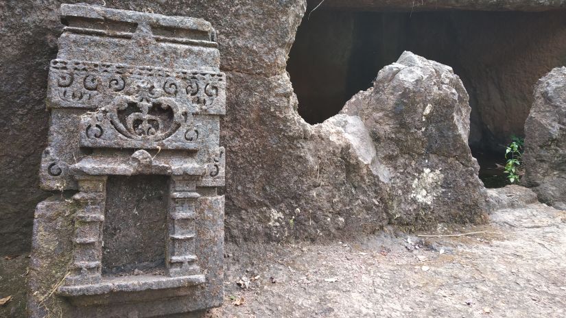 a rock sculpture outside a cave