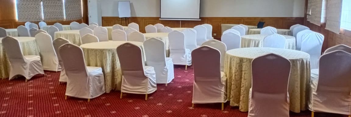 the indoor seating space at the conference hall - Monarch Luxur Hotel