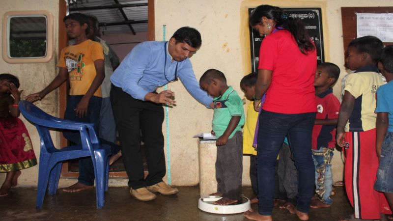 Doctor performing check-up at medical camp