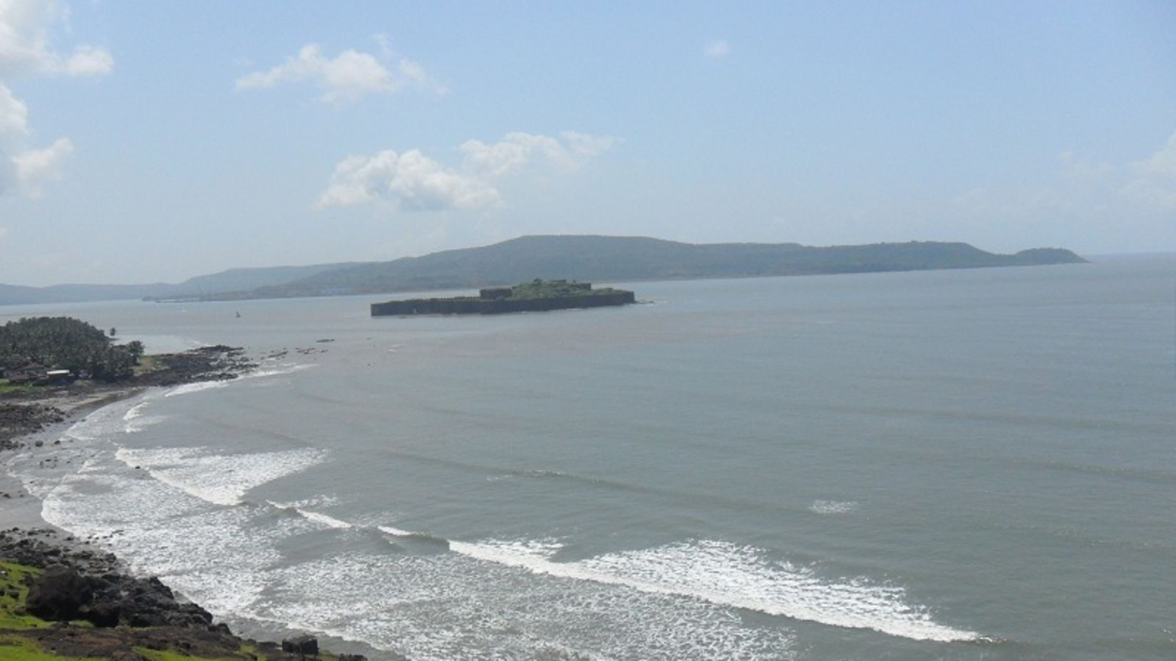 A scenic view of the Murud beach with greenery on one side