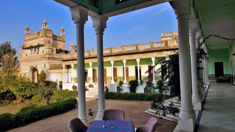 outdoor seating area with view of the lawn at The Piramal Haveli - 20th Century, Shekhavati