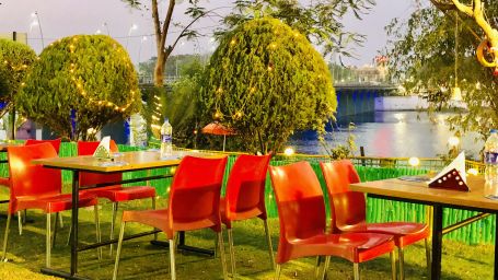 open air seating arrangement with trees next to it - VITS Kamats Resort, Silvassa