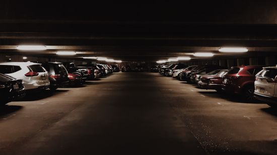 2 rows of cars parked in an underground basement
