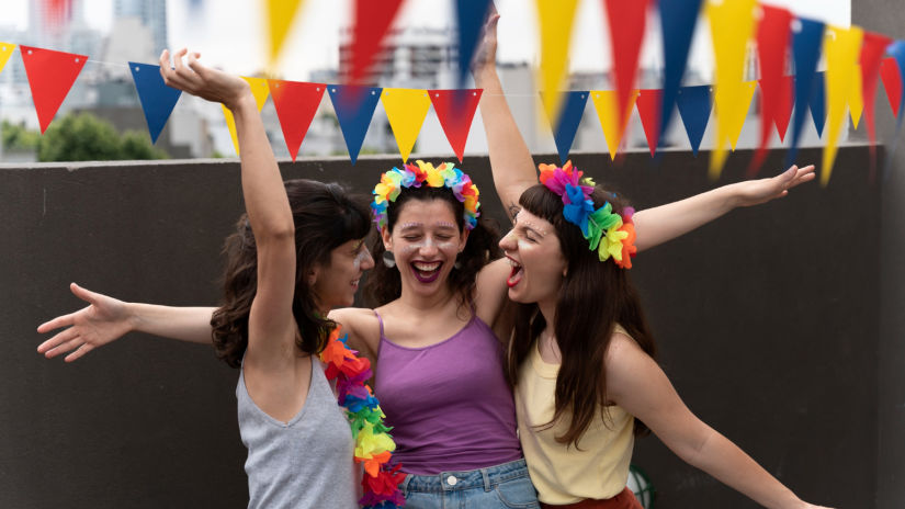 Image of 3 women celebrating during a carnival