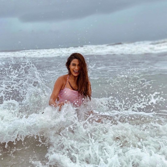 Lady smiling and playing in the beach