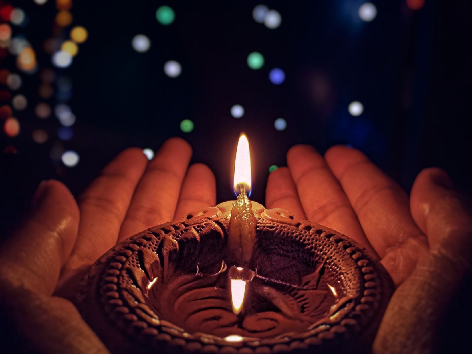 A diya being held 2