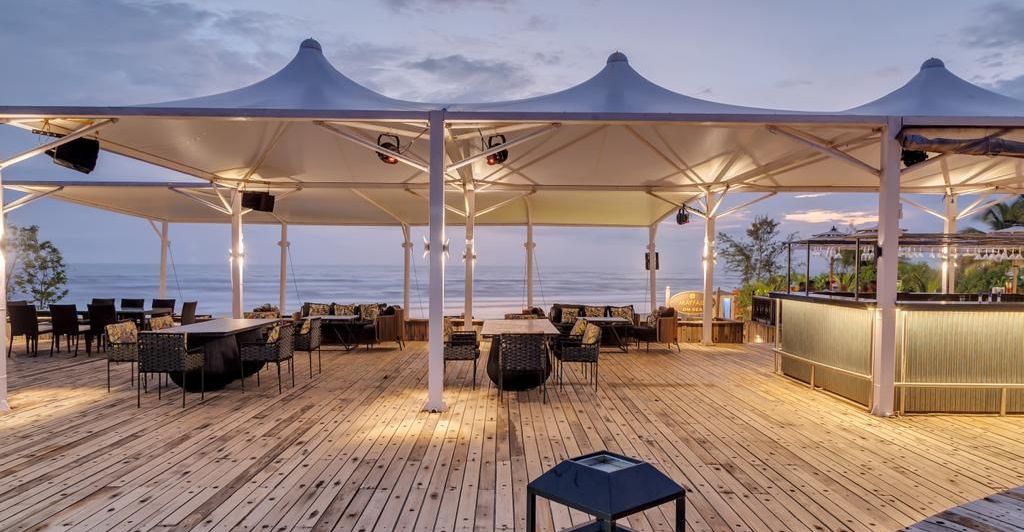 an outside cabana seating arrangement overlooking the beach - Mayfair On Sea, Morjim, Goa