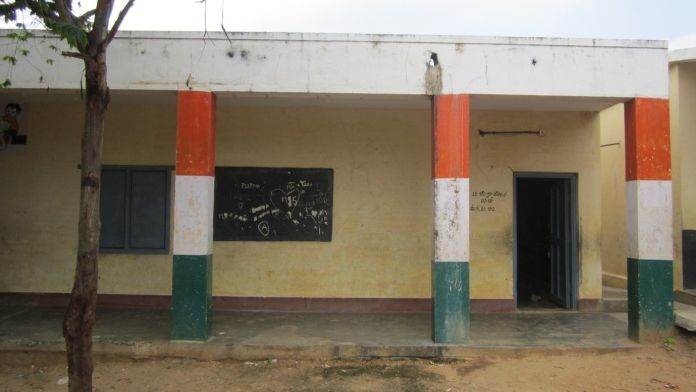 dull yellow building with tricolour pillars