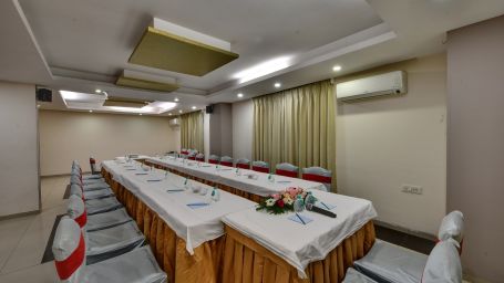 Another angle of the U-shaped meeting setup showcasing the entire room and wall decor - Click hotels Yuvraj, Surat