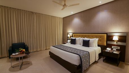 A deluxe room with a king size bed and a comfortable sofa - Grand Continent, Malleshwaram