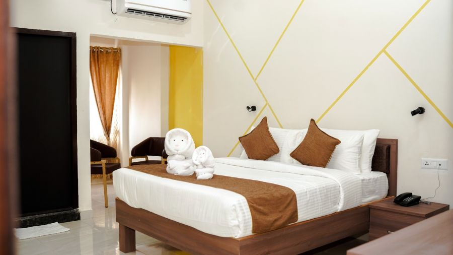 A well-lit room with a double bed at ANS M Square Hotel & Resort, Kalaburagi