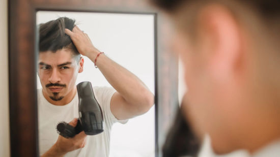 A-picture-of-a-man-blow-drying-his-hair