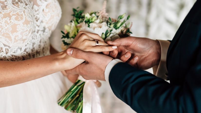 a couple exchanging wedding rings