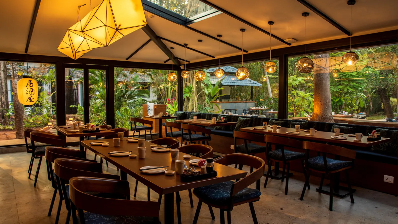 Long dining table in a restaurant with yellow lighting