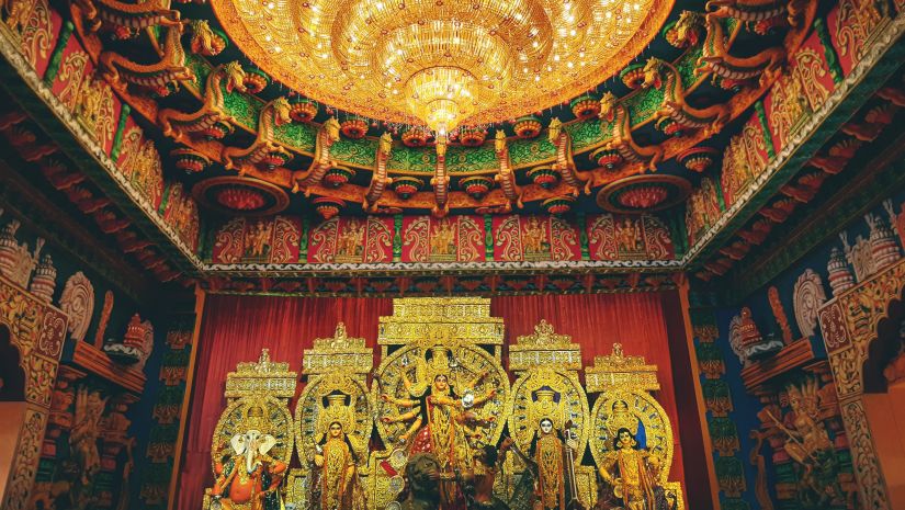 an image of durga puja pandal along with bright lights and devi durga idol