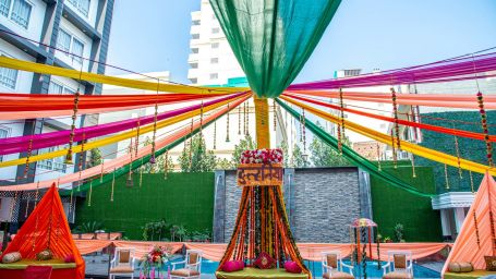 A low angle shot of a decorated event space beside the pool | Sun Park Hotel & Banquet, Chandigarh - Zirakpur