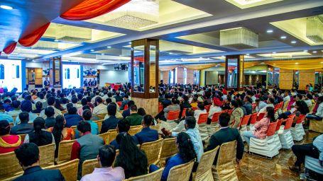 A back view of a conference hall with chairs occupied by poeple Sun Park Hotel & Banquet, Chandigarh - Zirakpur