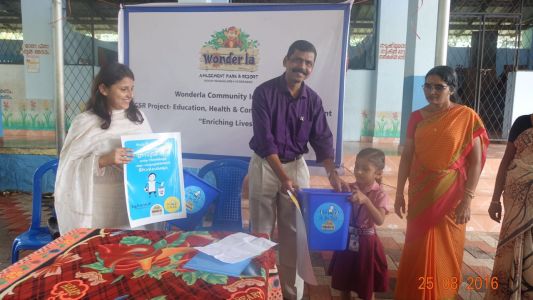 gifting school kid with a dustbin