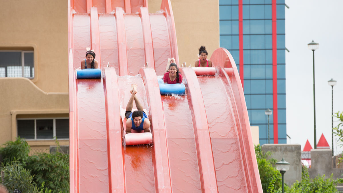 People going down a red water slide