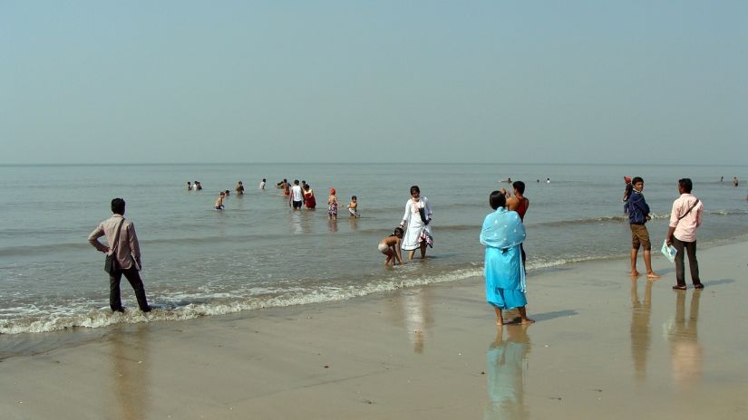 People standing near the shore on Juhu Beach