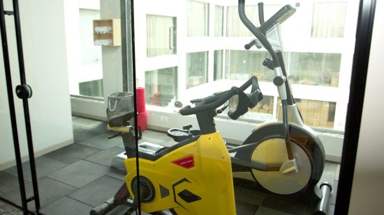 a cycling gym equipment inside a gym - Mastiff Hotel, Ankleshwar 