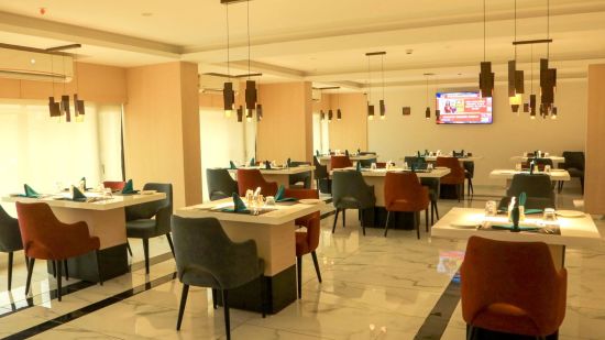 inside view of tangelo restaurant decorated with soothing ambience - Mastiff Hotel, Ankleshwar