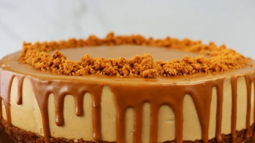 a picture of a cake kept on a tray with brown icing on it