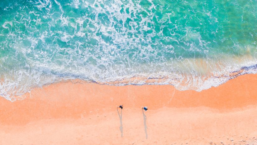 a clear beach with waves