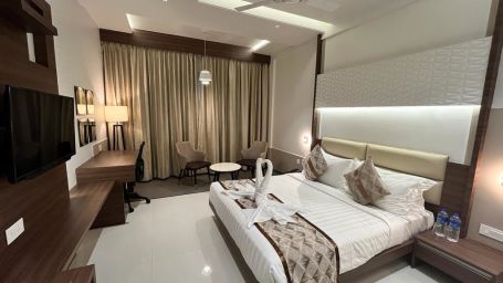 A full view of Deluxe Double Room with a plush double bed and bedding