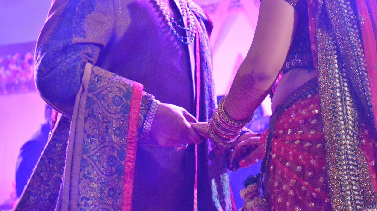 bride and groom holding each other's hands