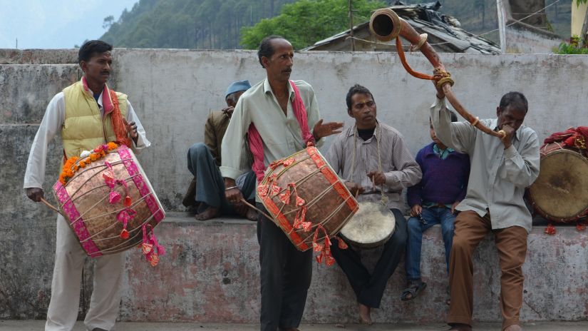 a group of people playing the dhak in Kolkata