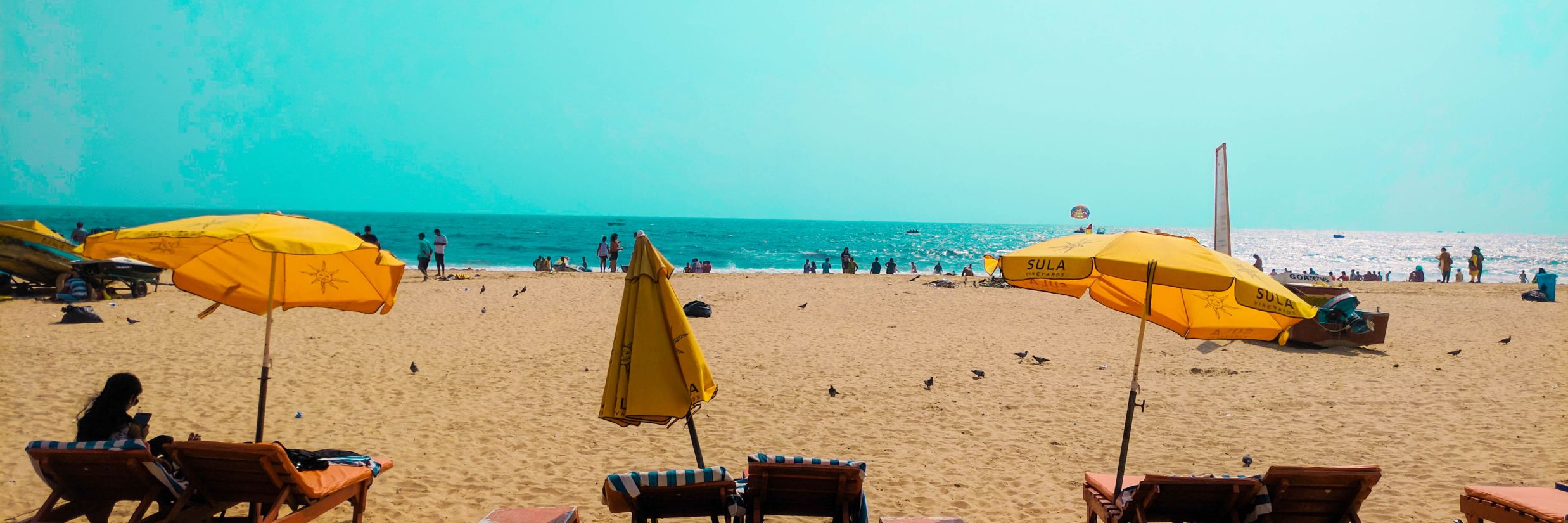 beach sand and yellow umbrellas @ Lamrin Ucassaim Hotel, Goa