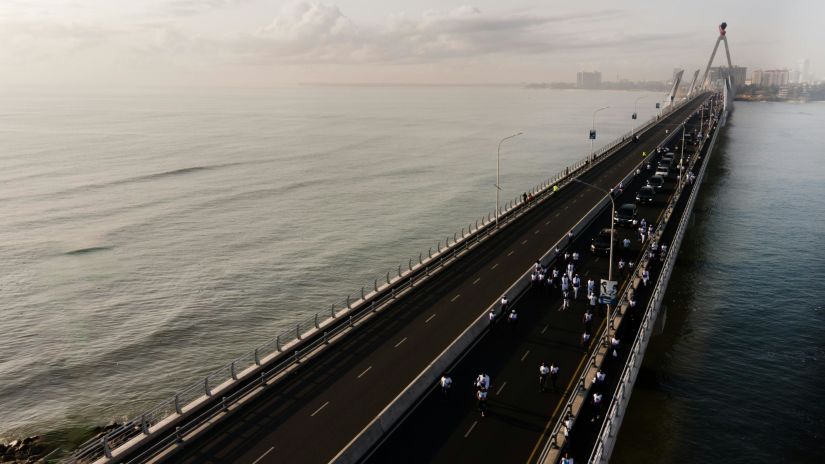 A two lane road in the middle of a sea.