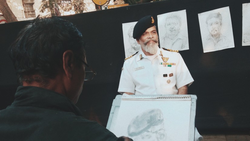 an artist painting a portrait at Kala Ghoda Festival Mumbai