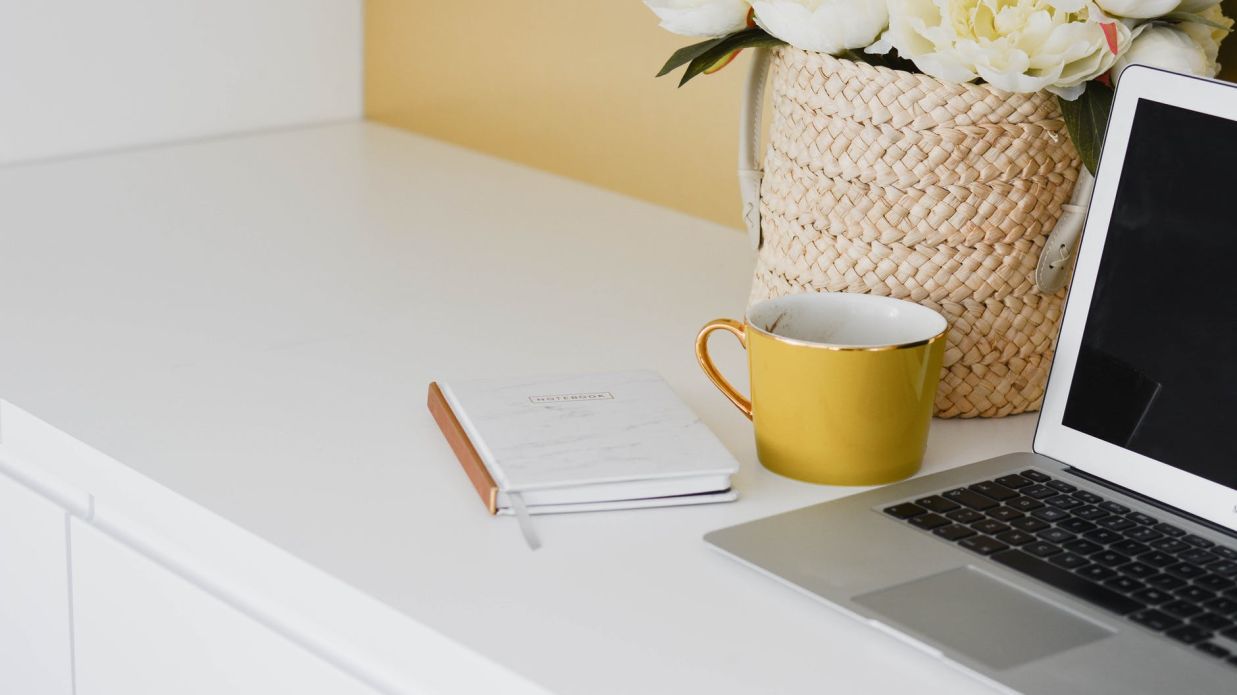 laptop and coffee cup on a table