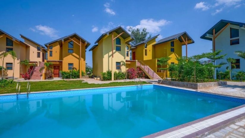 View of the poolside beautiful villas around it and the pool at Pride resort Ambaji