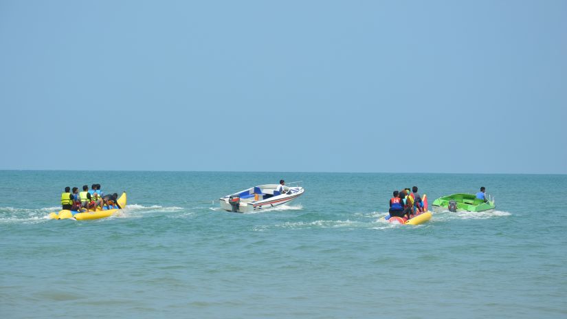 People enjoying banana boat ride on the beach