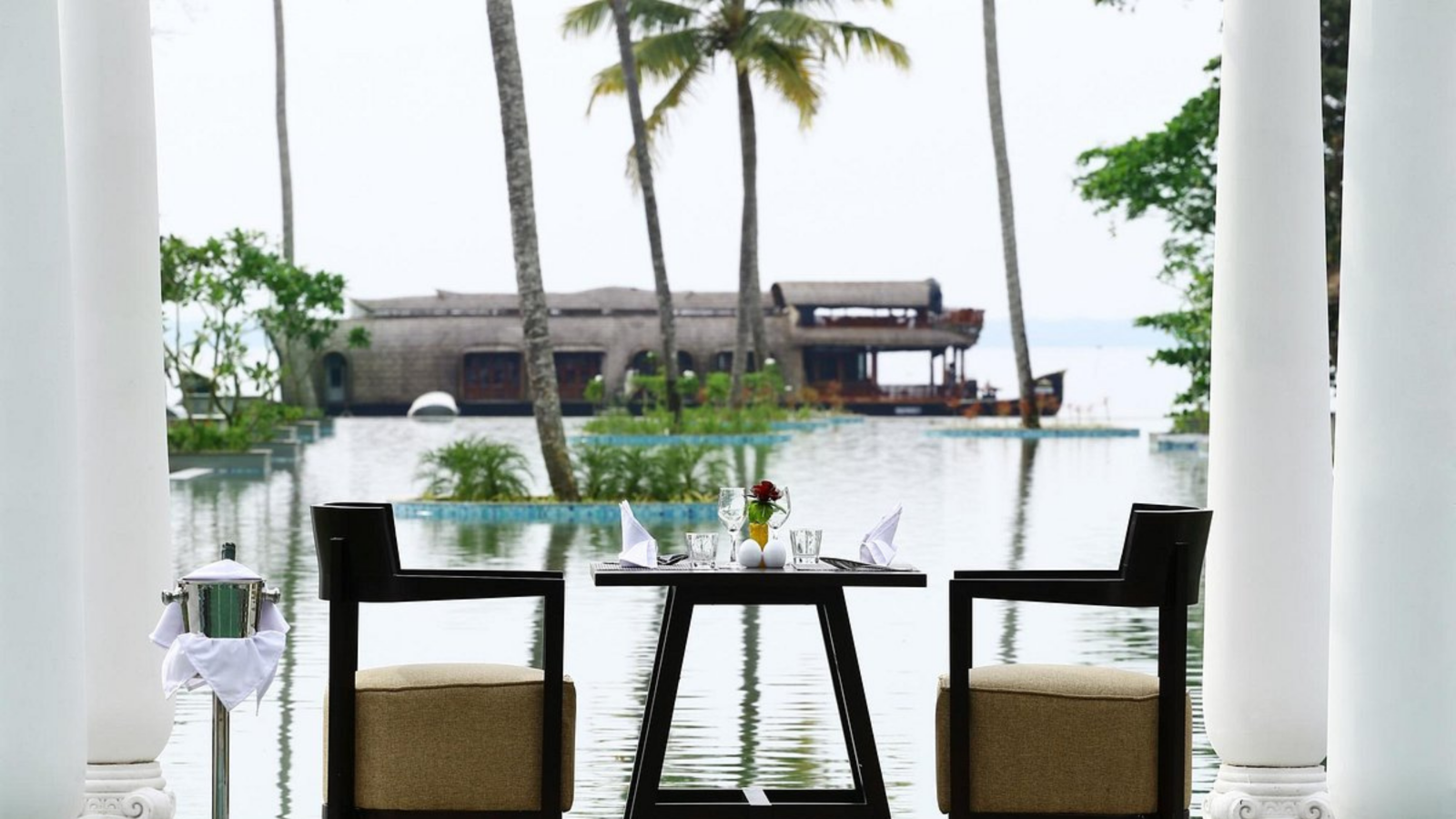 Dining table setup near with swimming pool in background