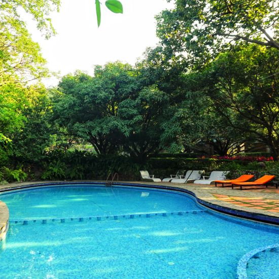 a swimming pool with sunbeds around