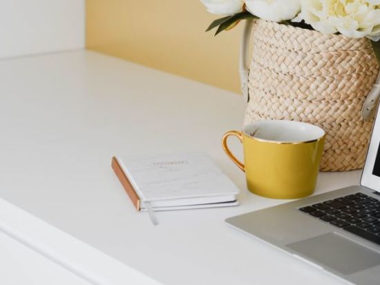 Coffee cup and laptop on a table