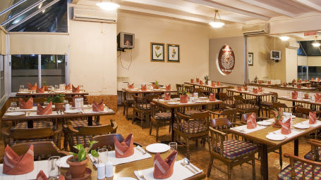 seating arrangements inside the Little chef Restaurant at Lotus Silvassa Resort in Silvassa