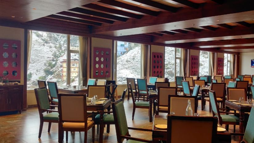 The simple and neat dining arrangements inside a dining venue - The Orchid Hotel Shimla